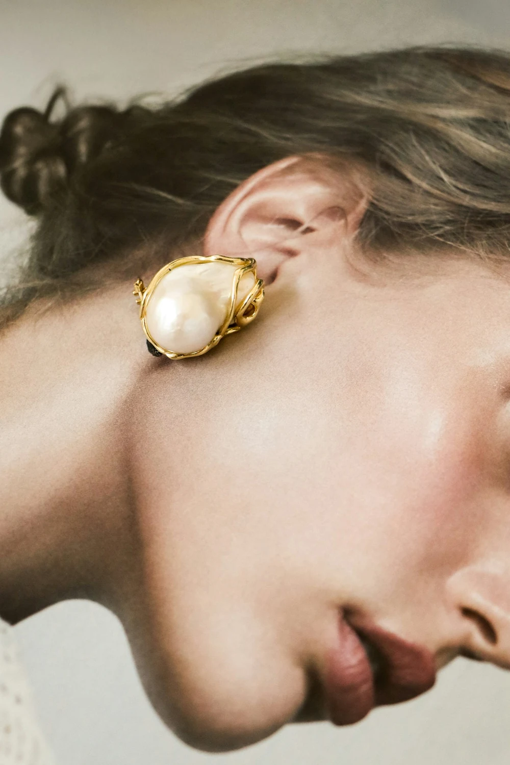 Pearl and gold earring worn on the ear