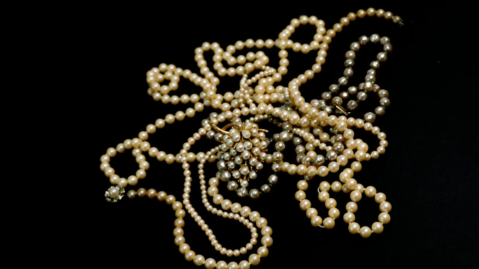Vintage pearl strands on a black background