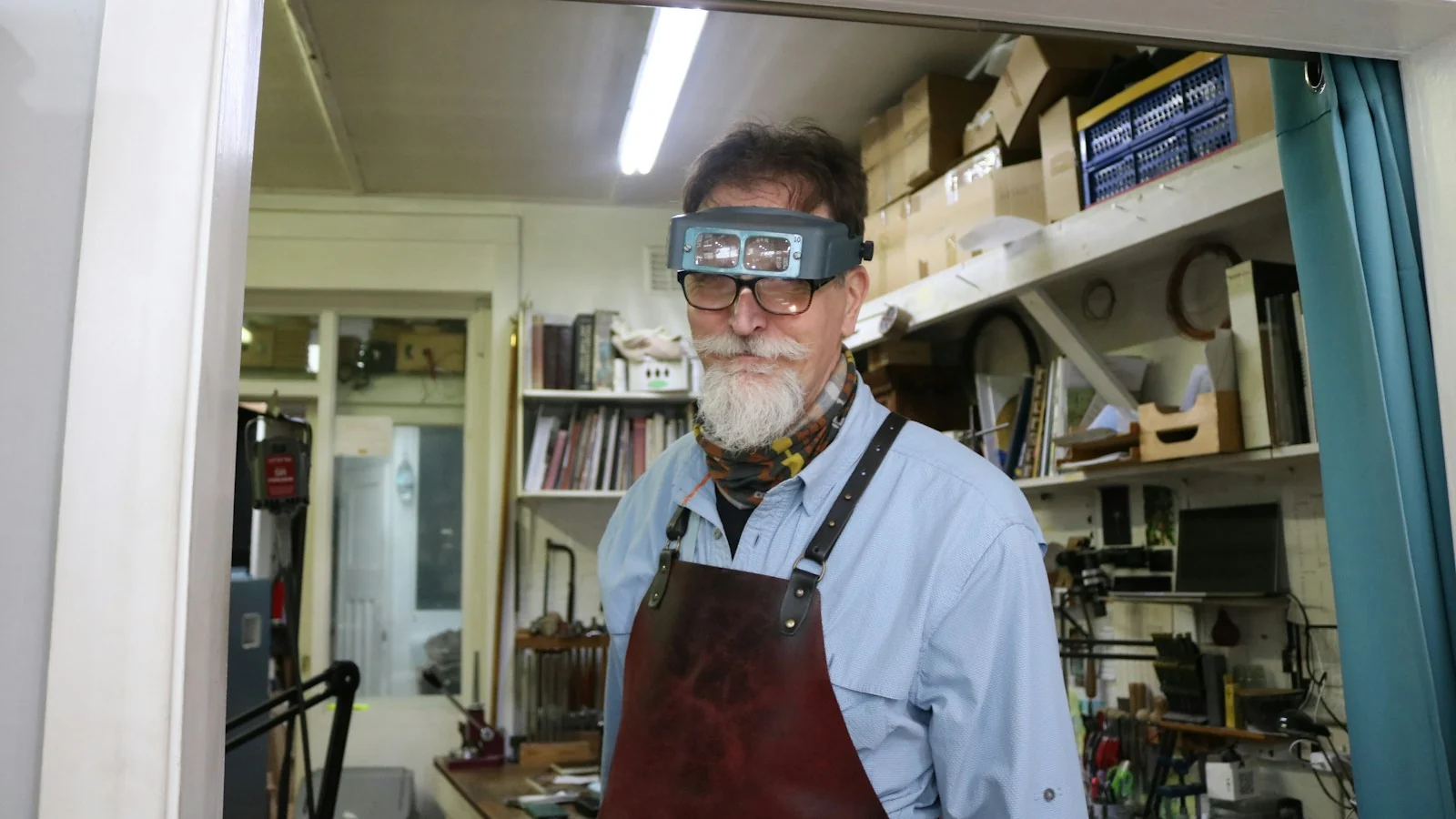 Jeweller wearing magnifiers in his workshop