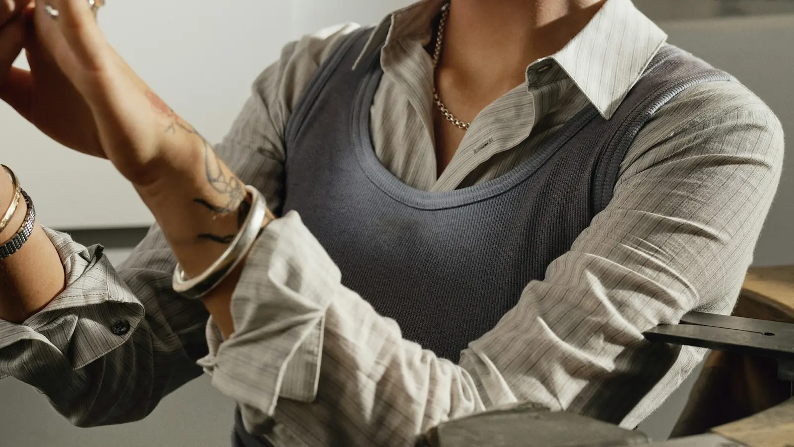 Jeweller examining a piece at her workbench