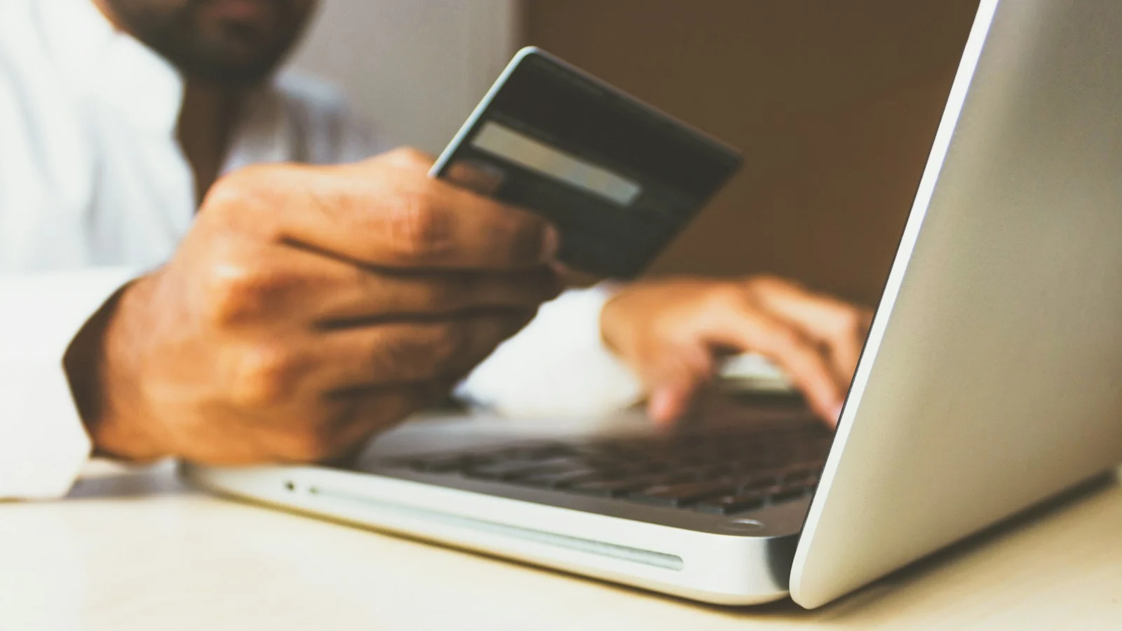 Buyer paying by card on a laptop
