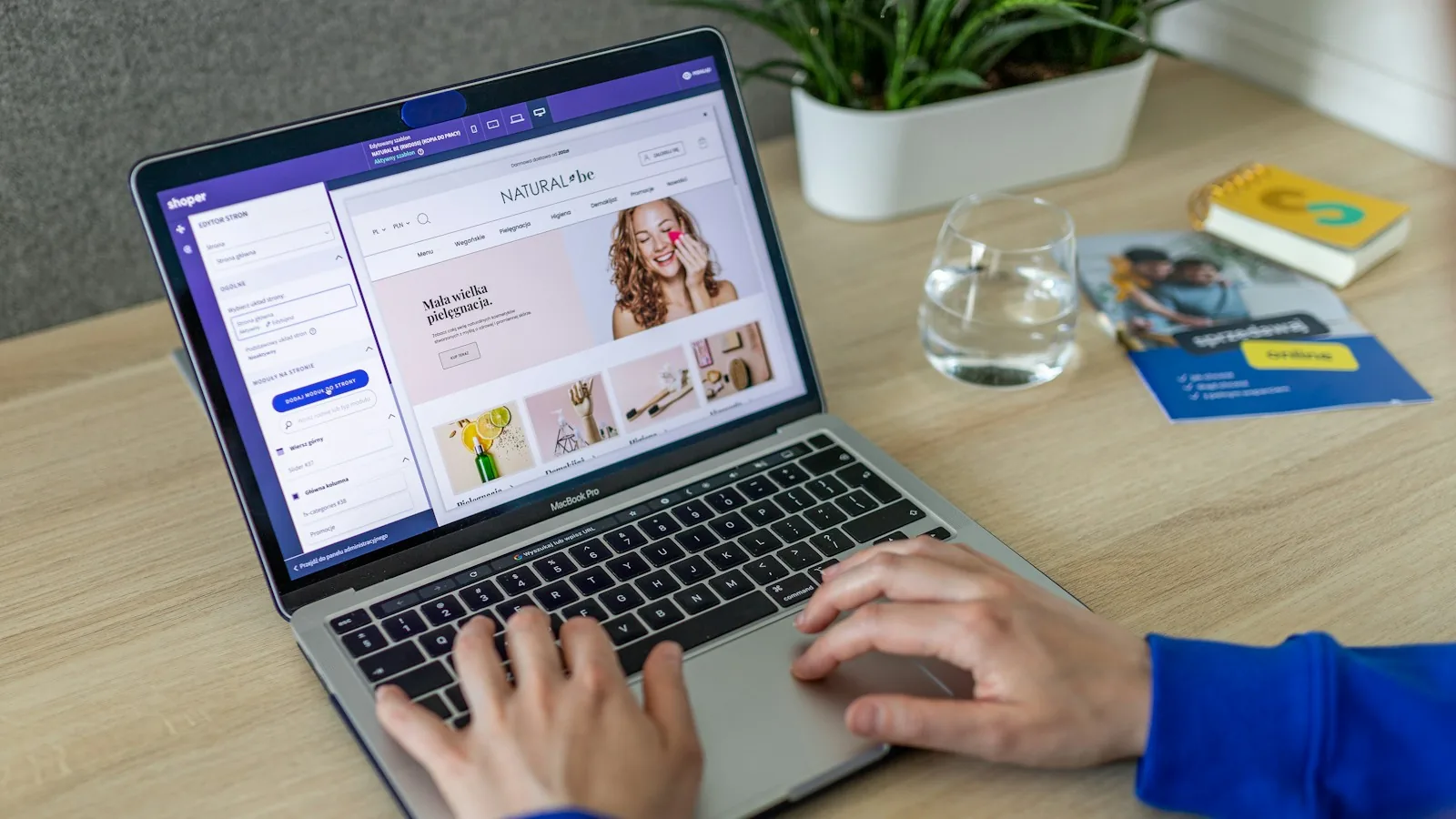 Hands editing an online store on a laptop