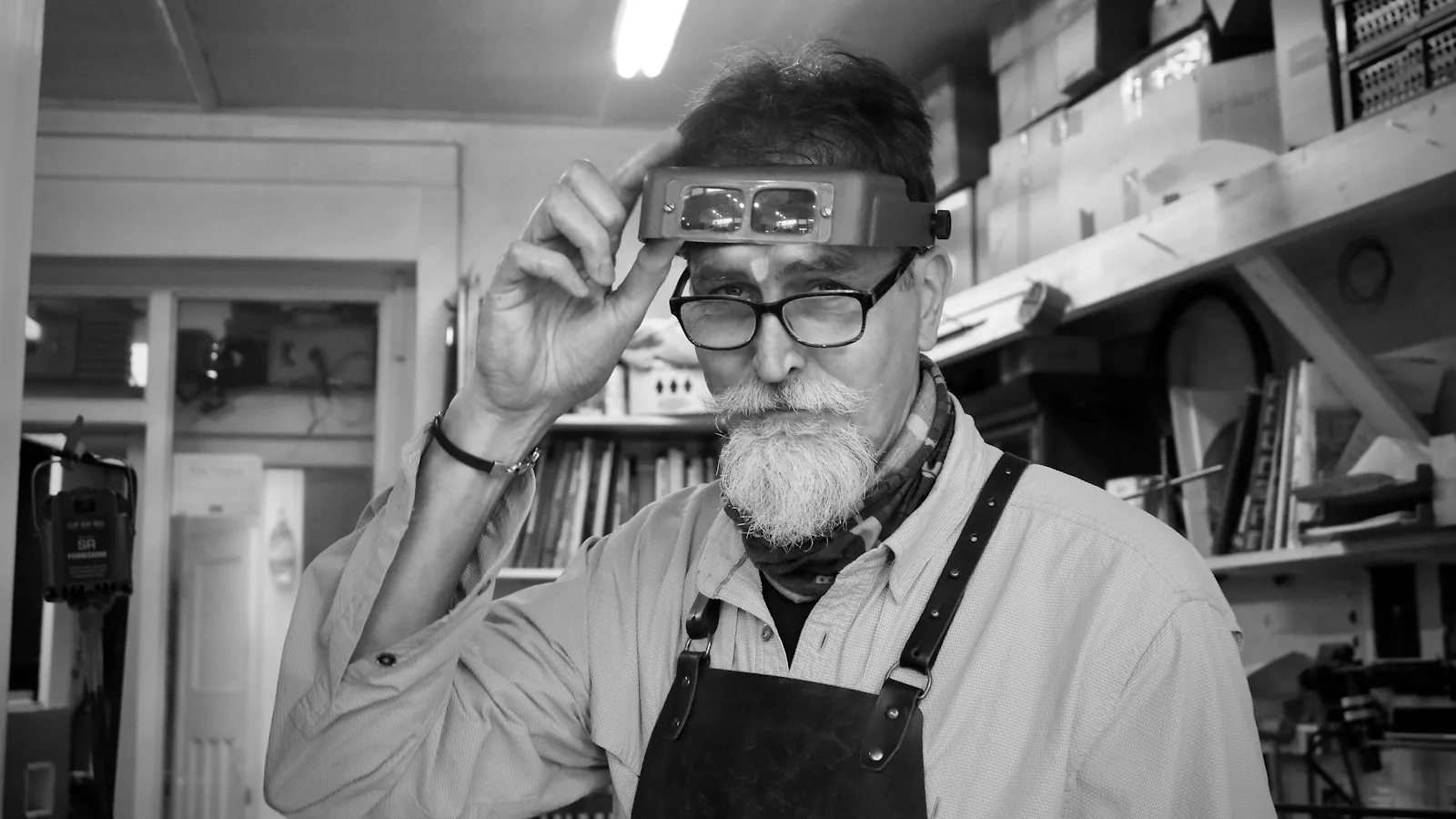 Jeweller adjusting magnifying glasses in the workshop