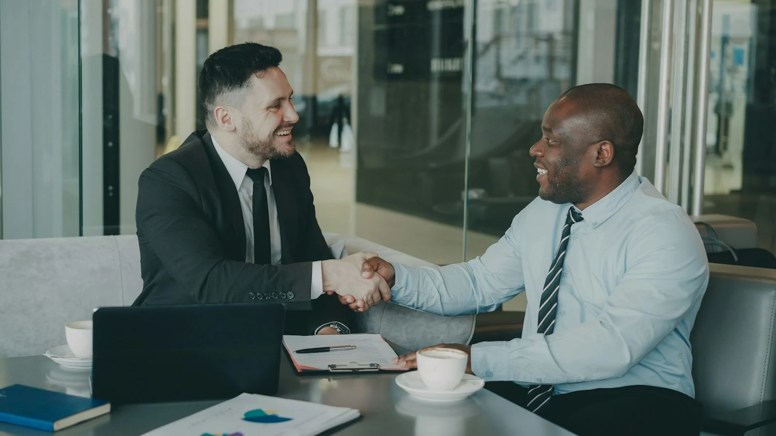 Two businessmen shaking hands after a contract meeting