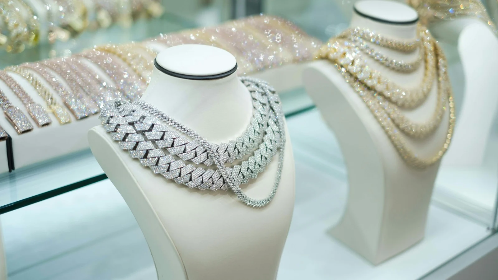 Necklaces displayed on busts in a jewelry showcase